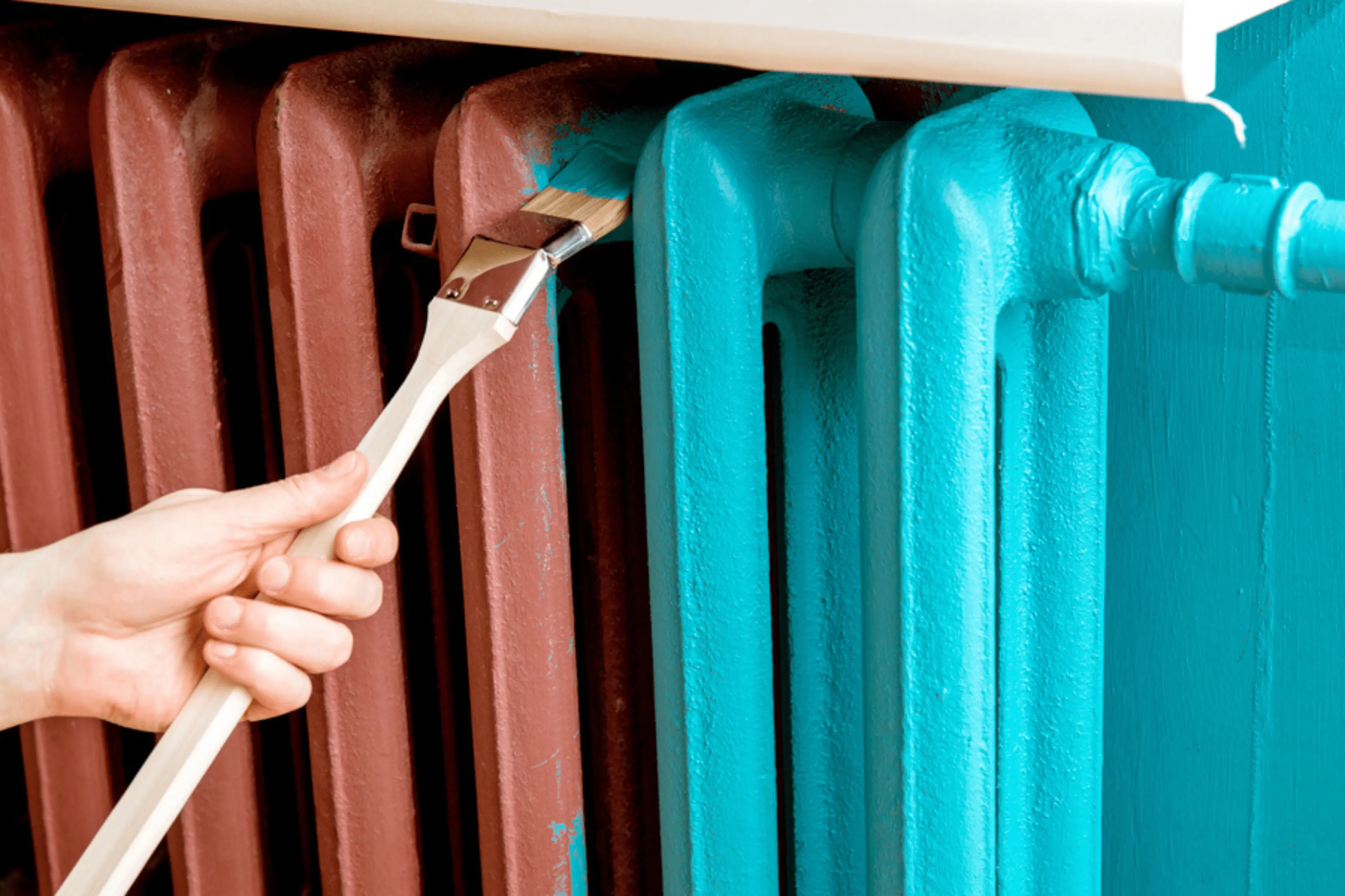 Homeowner Painting Radiator In Light Blue